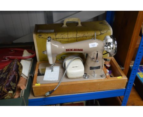 A New Home sewing machine, in fitted case, sold as a collector's item