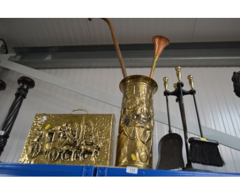 A brass embossed stick stand and contents; companion set and a brass embossed paper rack