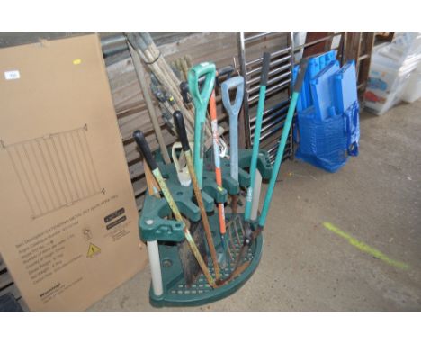 A quantity of gardening tools on stand, together with a bundle of draining rods etc.
