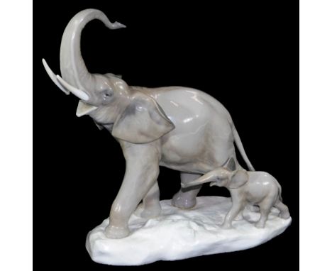 A 20thC Lladro figure of an elephant with calf, trunk raised, printed marks beneath, 31cm H.
