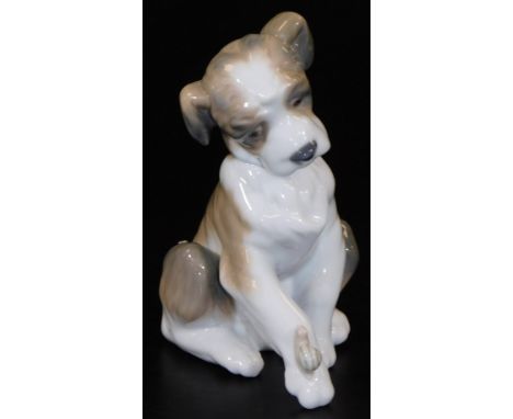A Lladro figure of a puppy, with snail to the leg, printed marks beneath, 13cm H.