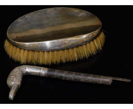 A stick top with duck head end in silver plate, 16cm H (AF), and a silver topped hairbrush. (2)