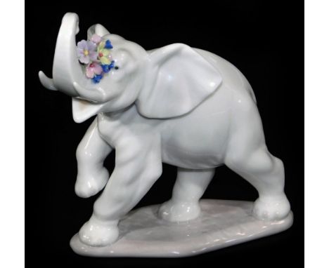 A Lladro figure of an elephant, with flowers to the trunk, no. 6461, printed and impressed marks beneath, 14cm H.