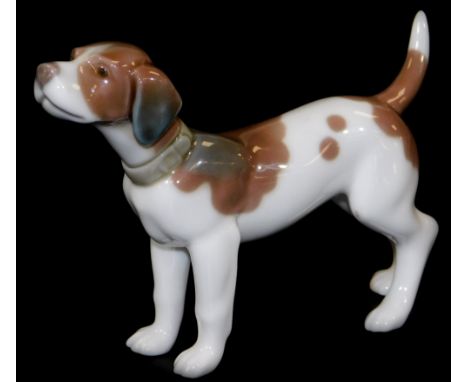 A Lladro figure of a standing hound, printed marks beneath, 9cm H.
