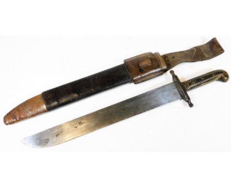 An early 20thC machete, of large proportion, with steel blade, shaped handle and leather scabbard with metal mounts, 70cm W.