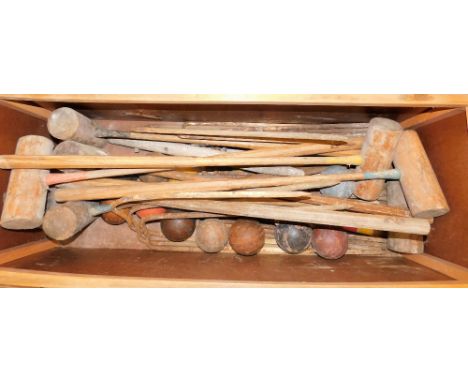 Various vintage croquet sets, to include hoops, mallets, balls, etc.  contained in a leather topped ottoman, 103cm W. The uph