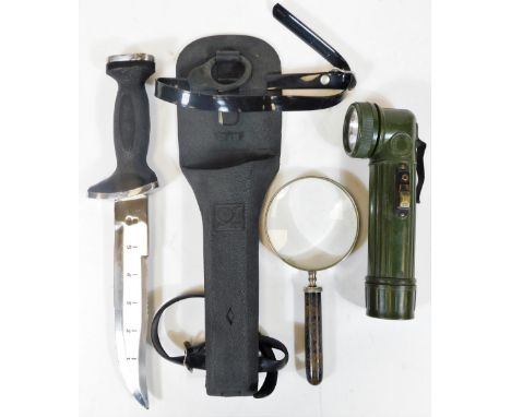 A Sun diver's knife, with chrome plated mounts and scabbard, 35cm H, a military torch of cylindrical form and a hand magnifyi