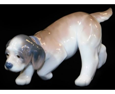A Lladro figure of a creeping puppy, printed marks beneath, 8cm H.