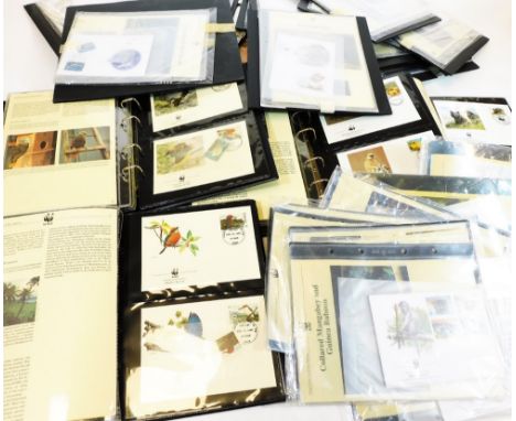 A large quantity of mounted first day covers, albums containing WWF first day covers, etc.