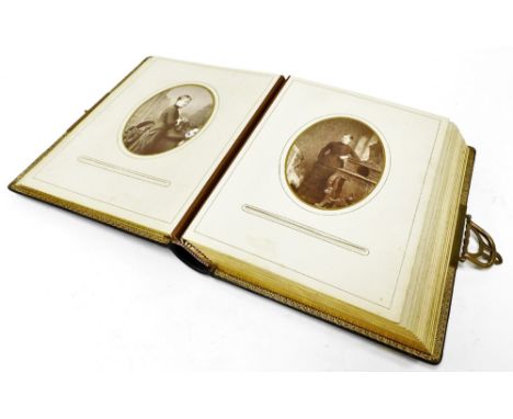 A Victorian black leather photograph album, with gilt coloured clasps, containing various photographs, black and white pictur