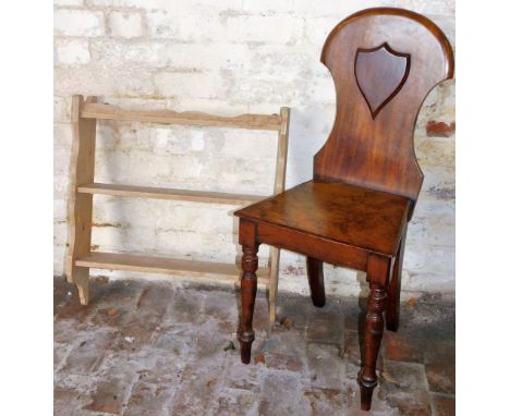 A 19thC mahogany hall chair, the shaped back with raised shield above plain seat on turned front legs, on turned front and sa