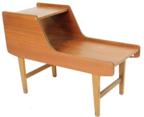 A vintage teak telephone table, of shaped form, on square tapering legs, 64cm H, 91cm W, 43cm D.