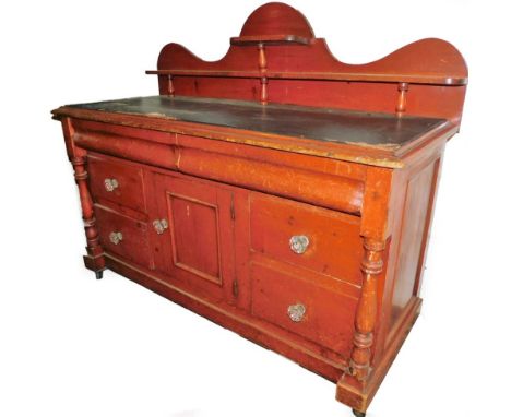 A 19thC pine Lincolnshire style dresser, with serpentine top and double shelf, each section held on baluster supports, with t