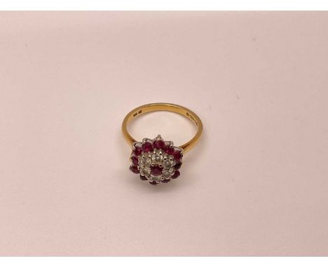 Ruby and diamond cluster ring with a cluster of brilliant cut diamonds and mixed cut rubies in tiered claw setting on 18ct go