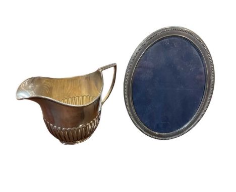 Late Victorian silver cream jug of half fluted form, with a reeded handle (Sheffield 1900) William Hutton &amp; Sons Ltd., to