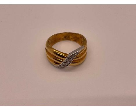 18ct gold and diamond ring with triple band in a crossover design, size P 1/2Weighs 10.5g.
