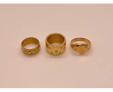 Three gold rings to include an 18ct gold and diamond signet ring, 18ct gold wedding ring and a gold/yellow metal and diamond 