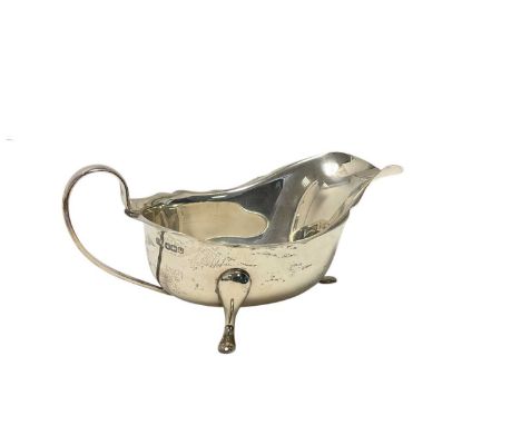 George VI silver sauceboat of helmet form, raised on three pad feet, (Sheffield 1938), maker Viners, 18cm in length, all at a