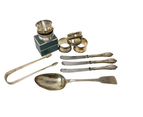 George III Irish fiddle pattern table spoon, (Dublin 1812), six silver napkin rings, sugar tongs and three silver handled kni
