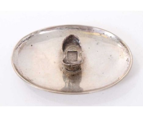Chinese silver dish of dished oval form on an oval base and mounted with a Chinese boat shaped silver Sycee ingot, underside 