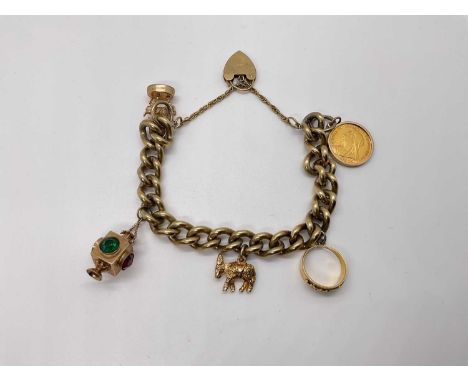 9ct gold charm bracelet with a collection of gold charms to include a Victorian gold half sovereign, an 18ct mizpah ring, and