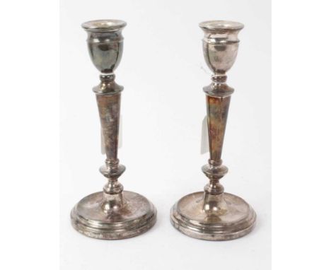 Pair of contemporary silver candlesticks, with tapering columns and urn candleholders, on circular bases, filled (Birmingham 