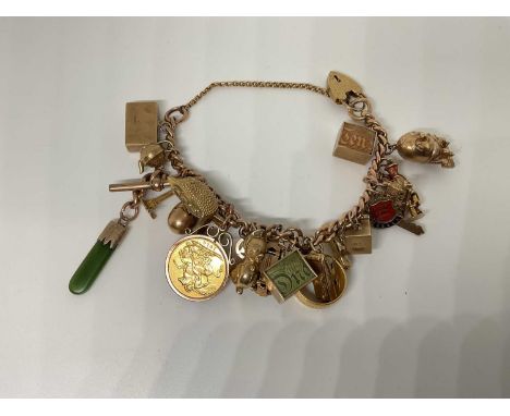 Gold charm bracelet, hallmarked 9ct, with a collection of 9ct gold and yellow metal charms to include a full sovereign, 22ct 