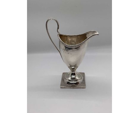 George III silver helmet shaped cream jug, on square base, London 1794, 14cm high3.05 troy oz.