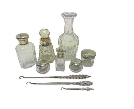 Six silver topped and silver collar glass toiletry bottles and three silver handled button hooks, (various dates and makers).