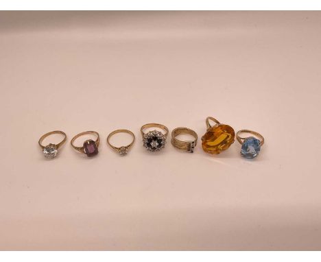 Seven 9ct gold and gem-set dress ringsTotal weight 30.2g. Six rings are roughly size M-O. The ring with a buckle design is si