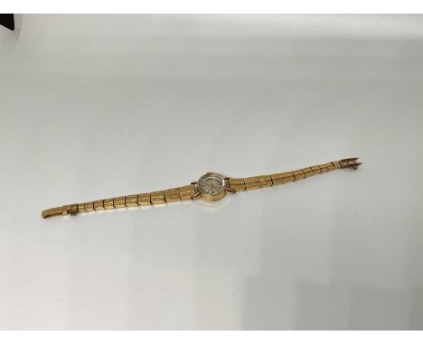 1950s ladies gold wristwatch on gold bracelet, the case stamped 18k and the strap with illegible marksStrap weighs 26.1g with