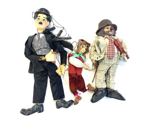 A mixed lot of vintage marionette puppets and a doll to include: - Charlie Chaplin puppet - Clown playing violin doll - Chara