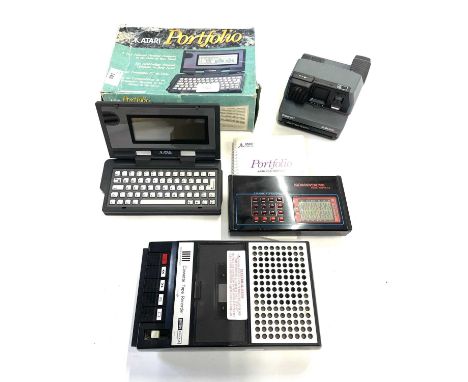 An Atari Portfolio in original box, 'A Full Featured Personal Computer in the palm of your hand', with a Polaroid Impulse AF 