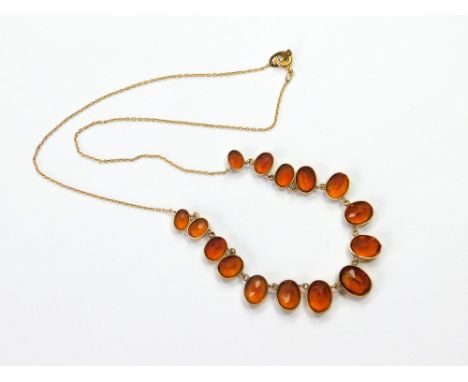 CITRINE NECKLACE. A 9k. mounted necklace, hung with 15 graduated citrine stones. Length 43cm. Condition Report: Very good, re