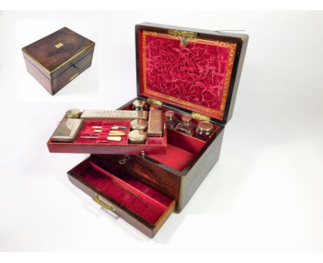 TOILET BOX. A 19th century, brass-bound, rosewood toilet box, fitted with a variety of cut-glass bottles & boxes, all with si