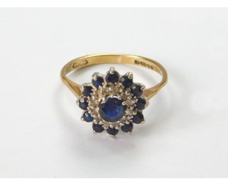 SAPPHIRE RING. A 9ct. gold, sapphire & diamond cluster ring. Size K. Condition Report: Shank has worn a little thin. All ston