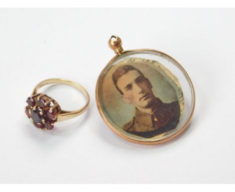 GOLD RING ETC. A 9ct. gold garnet set ring & a 9ct. gold mounted photograph locket. Condition Report: Please request a condit