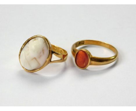 CAMEO RINGS. A 19th century, 18ct. gold ring, set a carved coral cameo, in closed-back setting. Size T. Approx 4.19g. Also, a