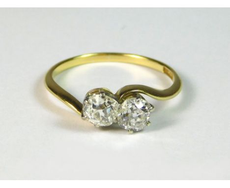 DIAMOND RING. An 18ct. gold, diamond-set crossover ring. Each stone of approx. 0.30ct. spread. Size M/N. Approx. 2g. Conditio