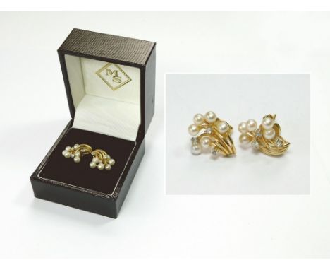 PEARL EARRINGS. A pair of 18ct. gold (tested) pearl & diamond ear studs. Each comprising six cultured pearls & three round br
