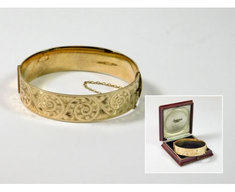 ENGRAVED BANGLE. A 9ct. gold on Bronze Core, hinged bangle, with engraved front. Condition Report: Very good.  Please note th
