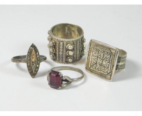 EGYPTIAN RINGS ETC. Two hand made, white metal Egyptian rings. Also, a silver & marcasite ring & a white metal dress ring, se