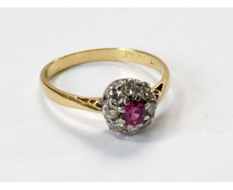 GOLD RING. An 18ct. gold & platinum, ruby & diamond cluster ring. Size N. Approx. 2.3g. Condition Report: Edges of top table 