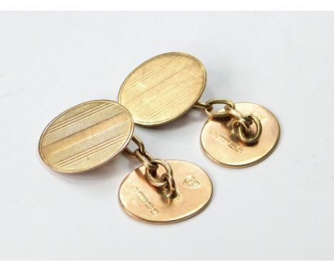 GOLD CUFFLINKS. A pair of 9ct. gold, engine turned cufflinks. Birmingham 1919. Approx. 8.08g. Condition Report: Surfaces a li