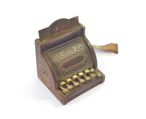 TAPE MEASURE. A brass novelty tape measure, a cash register. Tape intact, printed in inches & centimetres. Condition Report: 