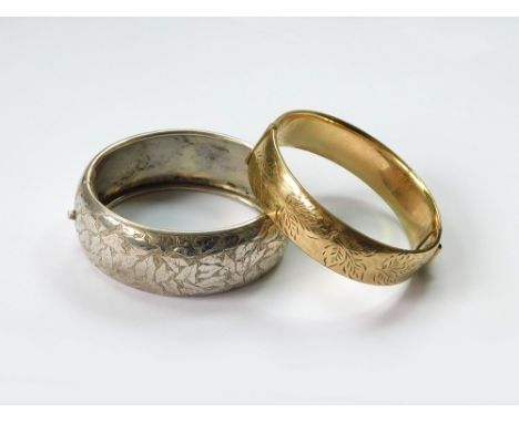 BANGLES. A Sterling silver, engraved cuff bangle, width 2.4cm. Also, a 9ct. gold, metal core, engraved bangle with expanding 