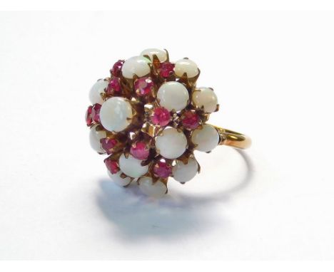 COCKTAIL RING. An opal & ruby-set domed cocktail ring, in yellow metal mount. Unstamped. Size J/K. Approx. 4.9g. Condition Re