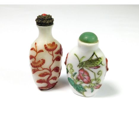 SNUFF BOTTLES. A Chinese red overlay, opaque glass snuff bottle, with metal stopper & spoon. Seal mark. Height 7.7cm. Also, a