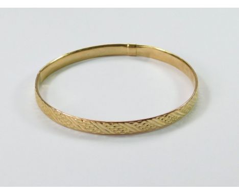 GOLD BANGLE. An Italian, 9ct. gold bangle. Internal diameter, 6.6cm. Approx. 3.8g. Condition Report: The bangle has two inter