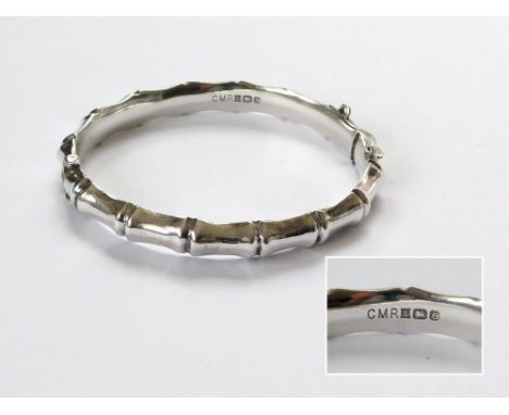 SILVER BANGLE. A silver hinged 'bamboo' bangle. Birmingham 1979. Condition Report: Very good.  Please note that all items in 